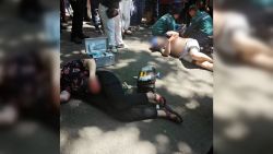 Victims of a stabbing attack are seen lying on the ground in Beishan Park, Jilin, China on Monday, June 10, 2024.