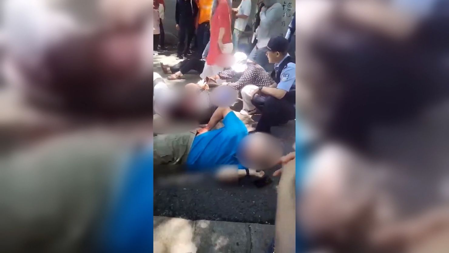 Victims of a stabbing attack are seen lying on the ground in Beishan Park, Jilin, China on June 10, 2024.