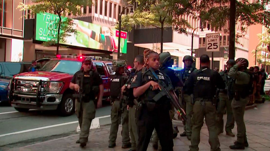 Law enforcement gathers near the scene of the reported shooting.