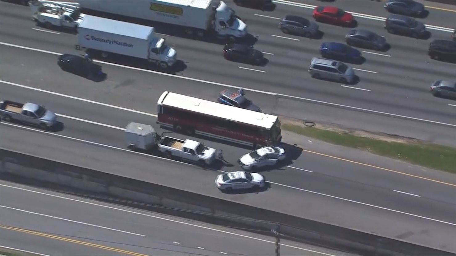 The bus hits a Gwinnett County police car as the chase moves through rush hour traffic.