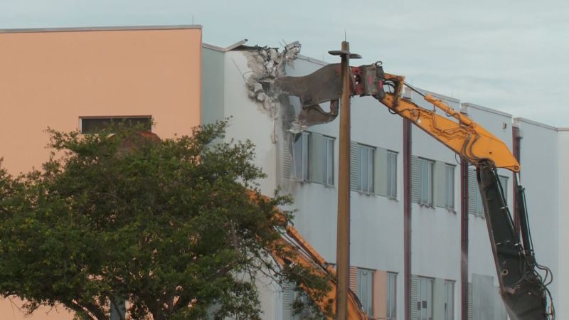 ‘A symbol of failure’: Demolition of Parkland high school massacre site begins as families of the victims look on