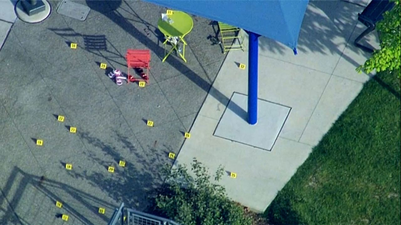 Evidence markers are placed at the scene of a shooting at a splash pad in Rochester Hills, Michigan, on Saturday, June 15.
