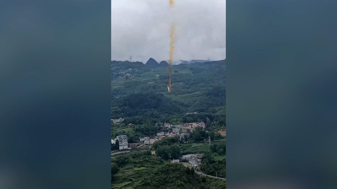 A screengrab taken from video shows suspected Chinese rocket debris falling over Xianqiao village, Guizhou Province, China, following a launch.