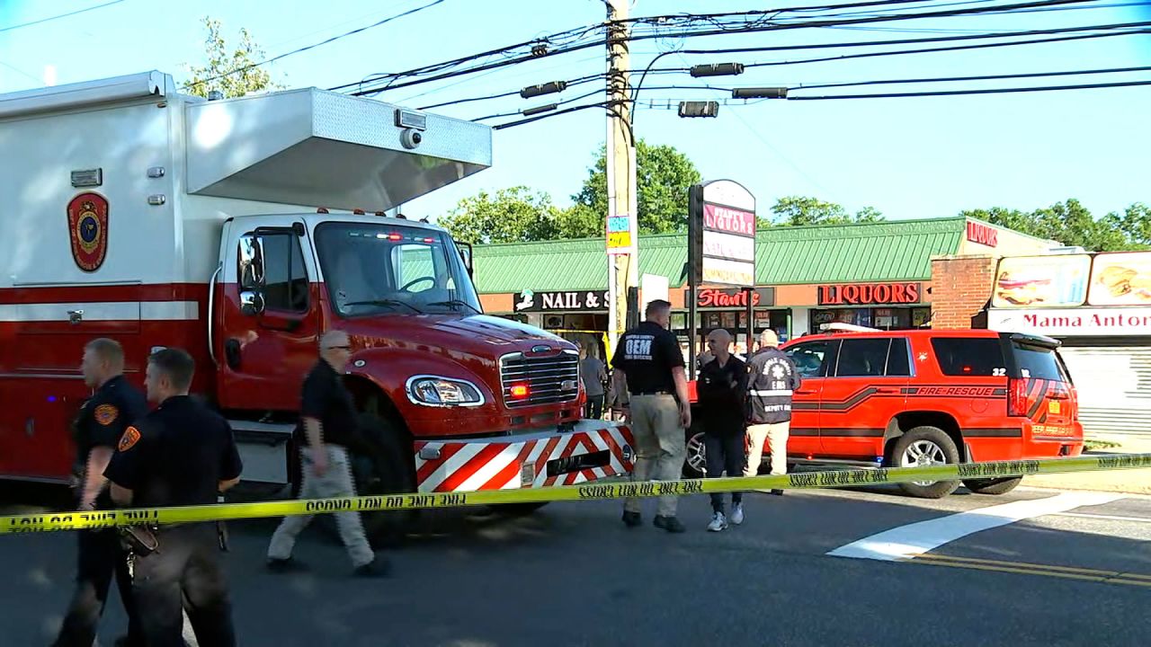 First responders on the scene after a minivan drove through a Long Island nail salon in Deer Park, New York, on Friday, June 28.
