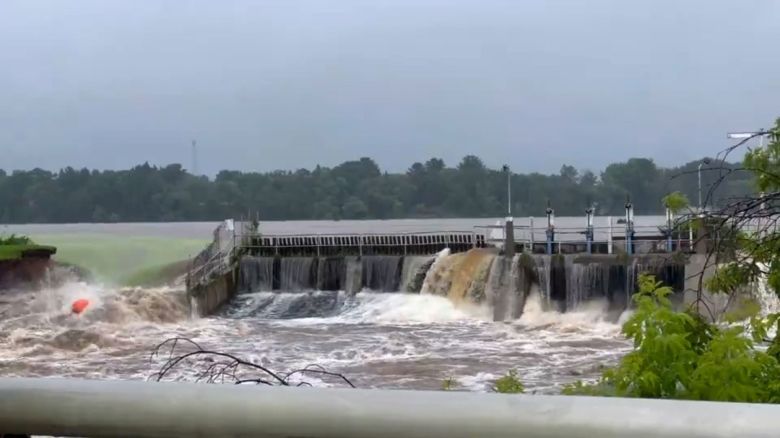 Water rushes from Manawa Dam in Wisconsin on Friday.