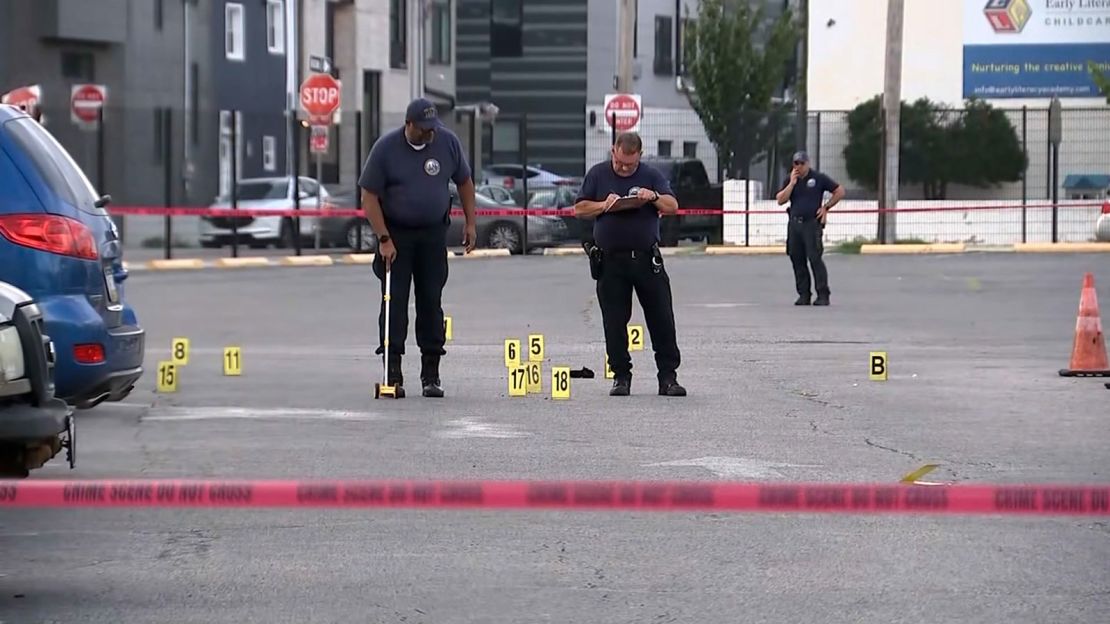 Police investigate in the parking lot where the shooting took place.