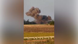 A screengrab taken from video released by the Ukrainian Air Force shows a drone on fire, falling from the sky and landing in a field — causing a large cloud of smoke but no visible damage.