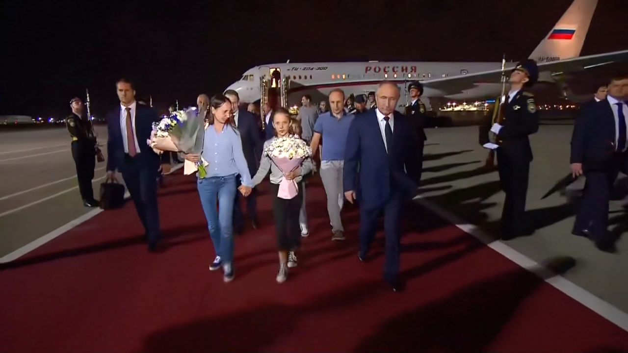 Russian president Vladimir Putin receives the Russian citizens released in the prisoner swap as they disembarked the plane upon arrival in Moscow from Ankara on Thursday, August 1.