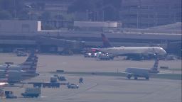 Emergency vehicles are seen Chicago O'Hare International Airport after a dead woman was found entangled in baggage machinery.