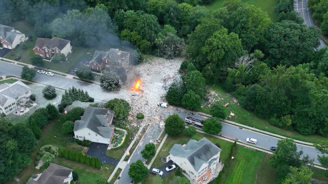 A fire burns at the scene of a house explosion on Sunday in Harford County, Maryland.