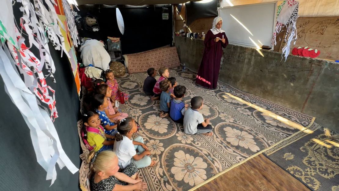 Oula Al Ghoul, a Palestinian teacher, has established a makeshift classroom for displaced children in Deir al-Balah, central Gaza.