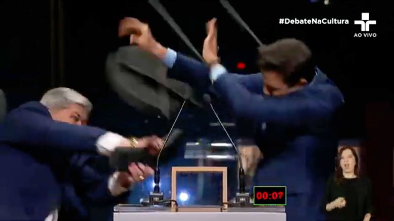 Candidate for Sao Paulo Mayor Jose Luiz Datena, left,  throws a chair at his opponent Pablo Marcal during a televised debate, in Sao Paulo, Brazil, on Sunday, September 15