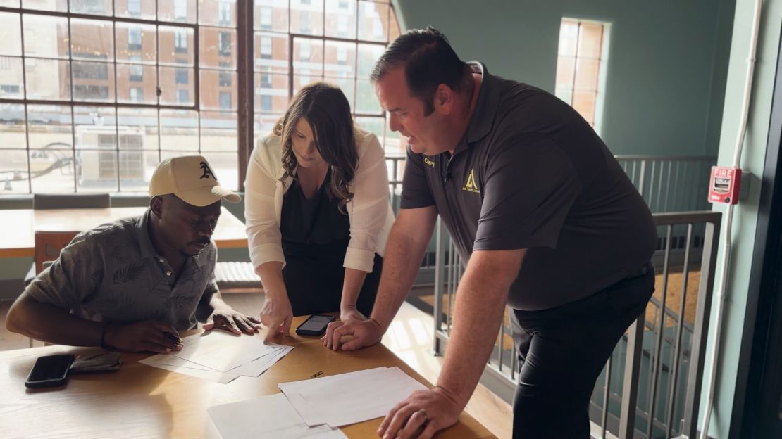 Corey Worden, president of Job Talent Connect, and Rachel Worden, regional director of operations, help a Haitian man applying for employment.