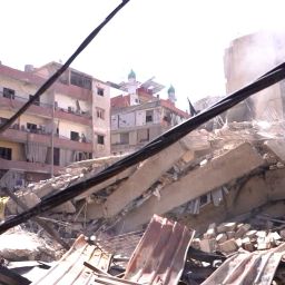 Smoke rises over rubble left after an Israeli strike in the suburbs of Beirtu on Wednesday, October 2.