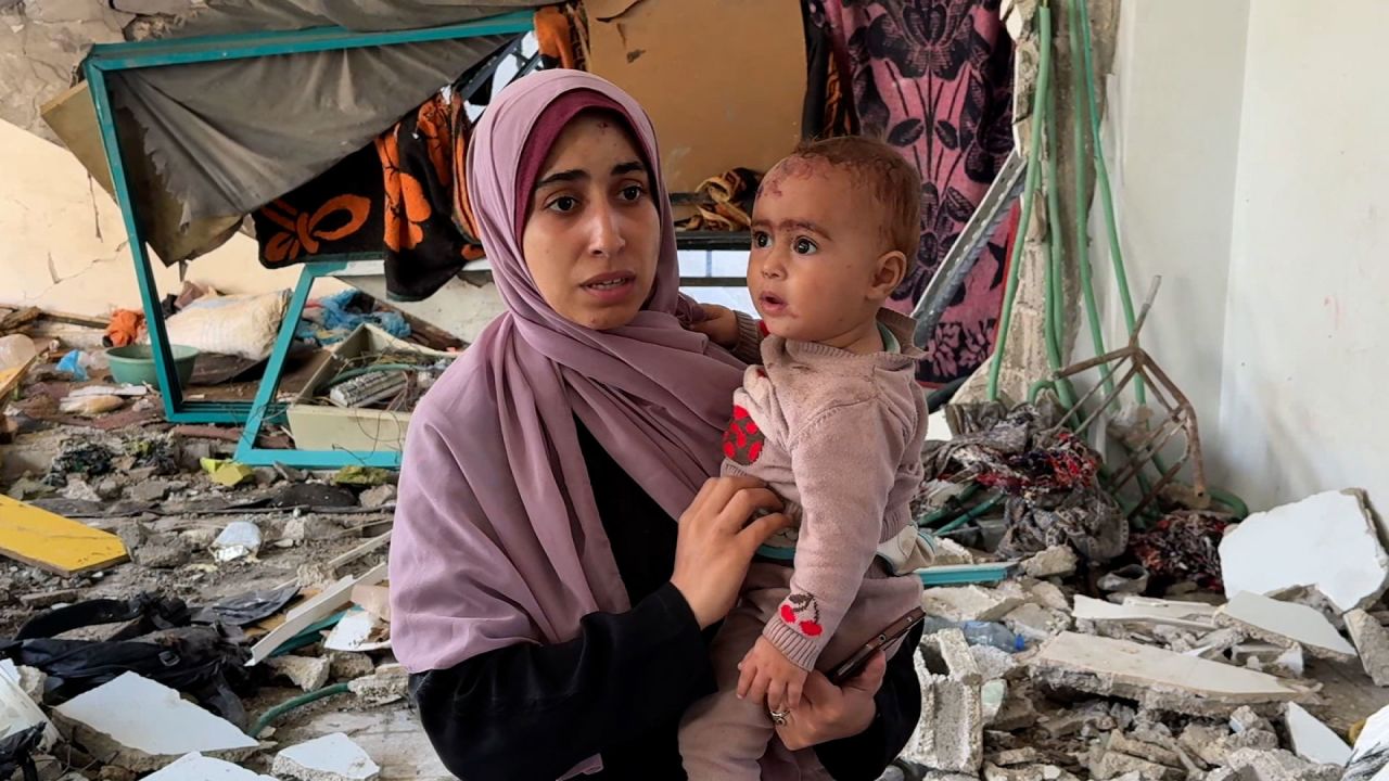 Asma speaks to CNN standing in the rubble of the struck school in Deir al-Balah, Gaza.