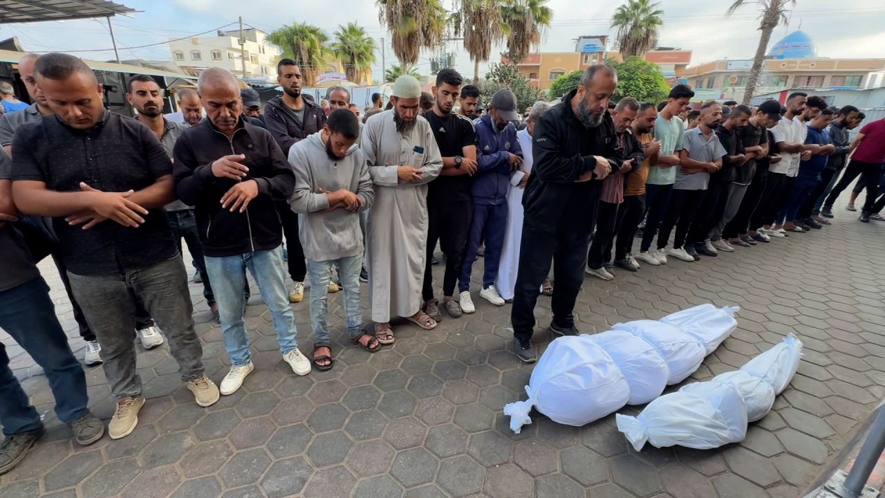 Rows of men and boys perform Janazah, Islamic funeral prayers, for Palestinians killed by an Israeli attack in central Gaza, on October 8.