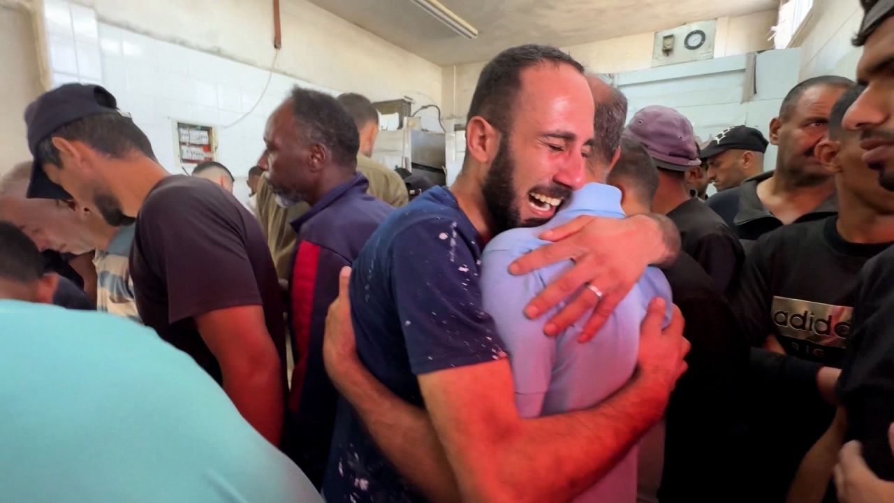 Family members grieve at Al-Aqsa hospital in central Gaza on October 13, after a young man was killed by an Israeli strike on the Bureij refugee camp.