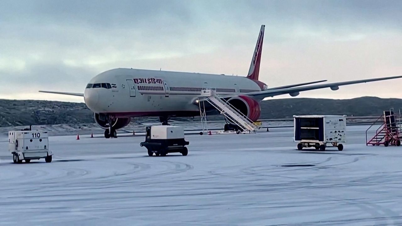 In this screengrab taken from a video, an Air India plane intended for Chicago sits on a runway in Iqaluit, Canada, on October 15, after making an emergency landing due to a bomb threat.