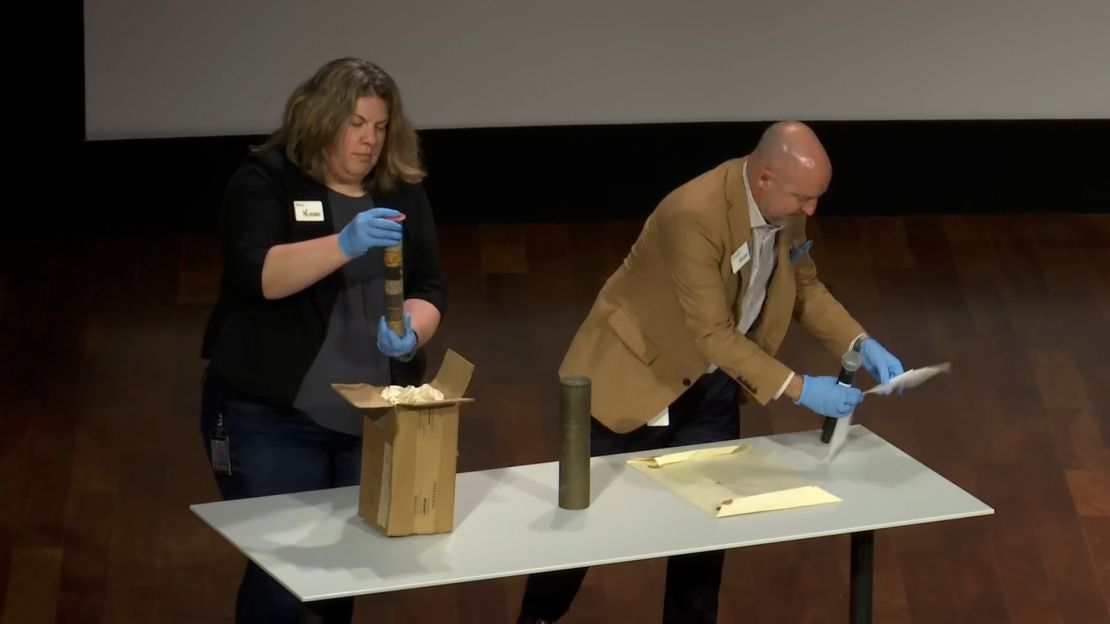 Museum curators unveil three unopened artifacts from the century-old time capsule.