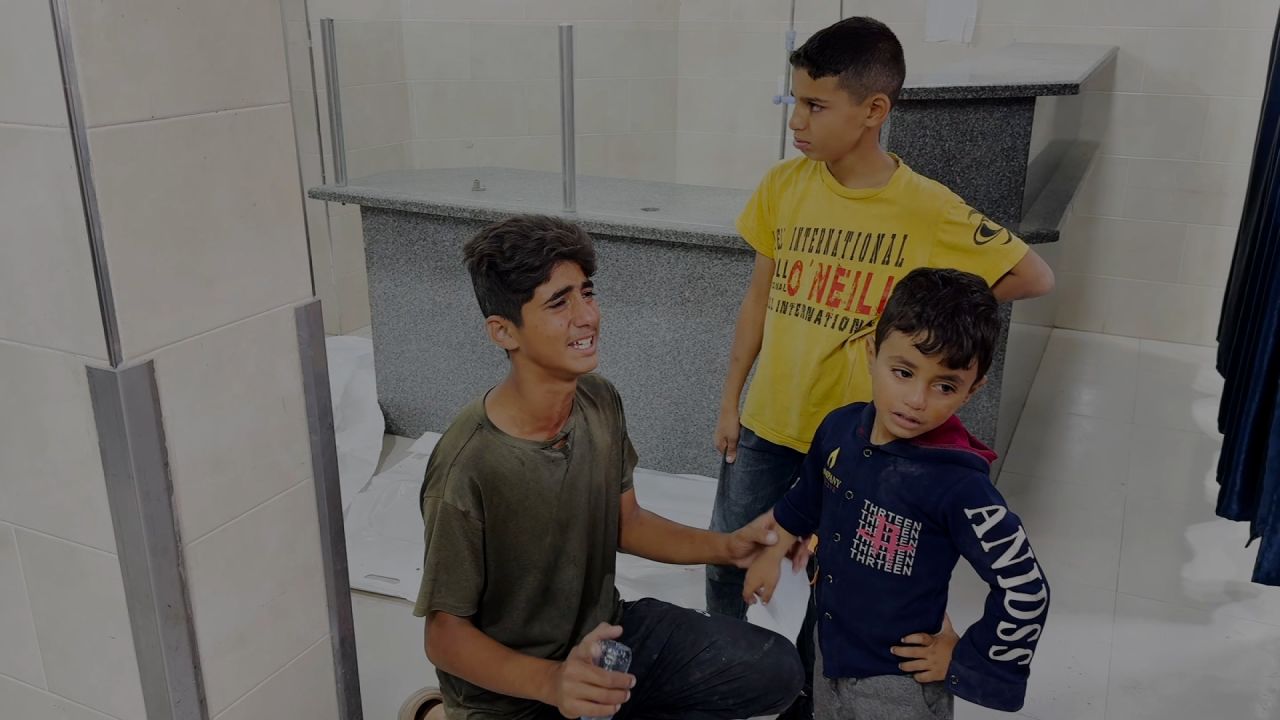 Baraa Al Far (left) can be seen with other Palestinian boys in the morgue of Al-Awda Hospital, after an Israeli airstrike in Nuseirat on Thursday.