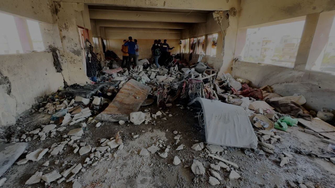 CNN video shows Palestinians surveying the destruction of an Israeli airstrike on Al-Shuhada school, in Nuseirat, in central Gaza, on October 24.