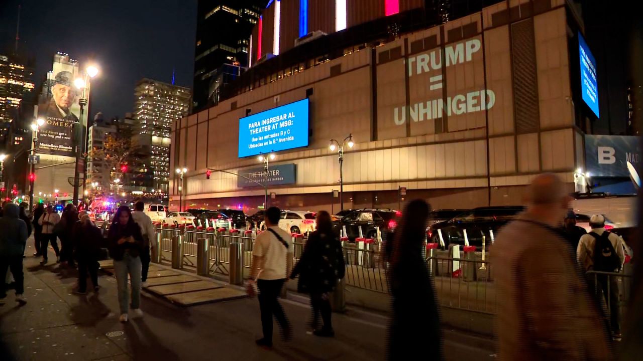 A projection reads "Trump = Unhinged" outside Madison Square Garden in New York, where former Donald Trump is holding a rally Sunday evening.