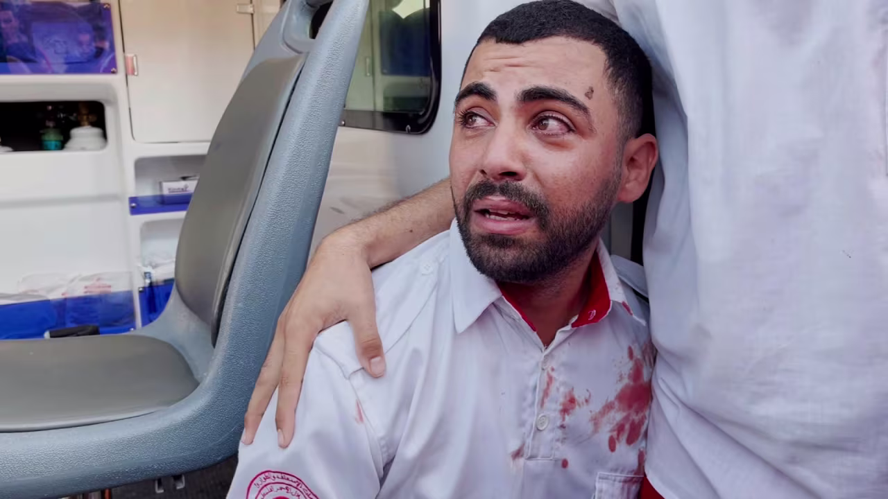Abdulaziz Al-Burdini is comforted by his colleagues after realizing his mother was killed in an Israeli airstrike in central Gaza on October 30.