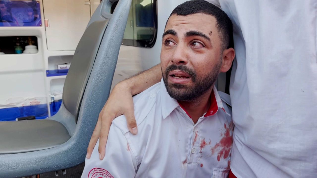 Abdulaziz Al-Burdini is comforted by his colleagues after realizing his mother was killed in an Israeli airstrike in central Gaza on October 30.