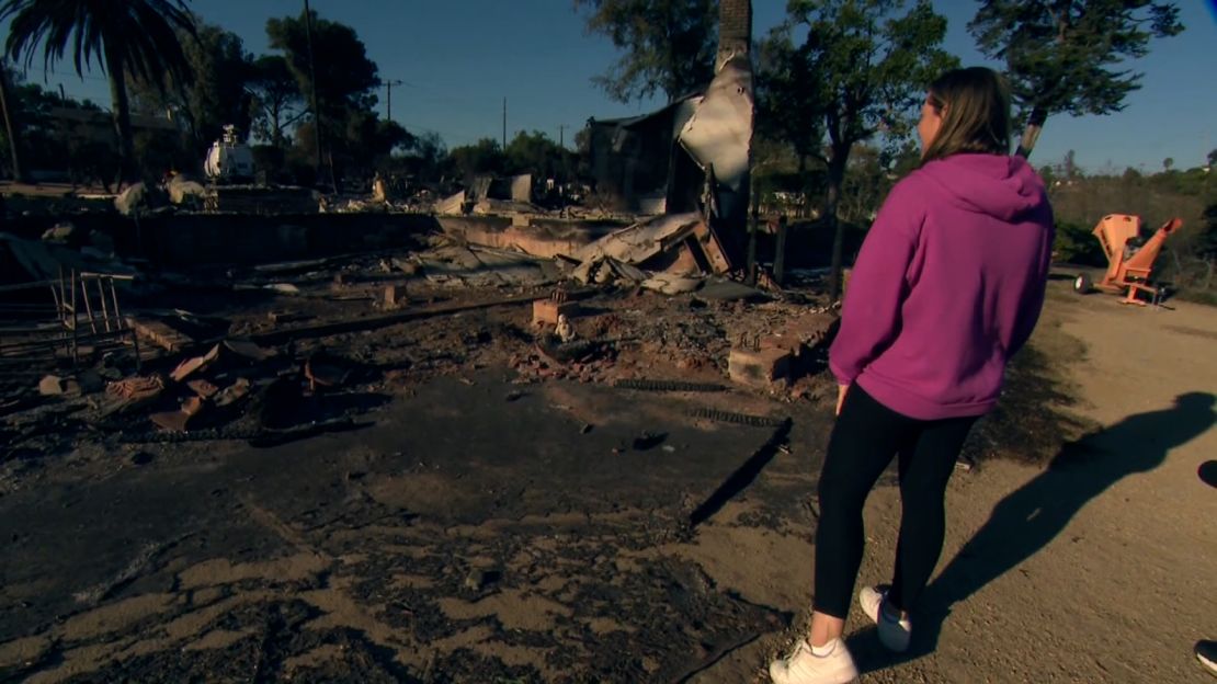 Jamie Randall looks at the rubble of her home in Camarillo, California, on Saturday. Randall and her husband said they plan to rebuild.