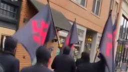 Flags with red swastikas are carried Saturday through downtown Columbus, Ohio.