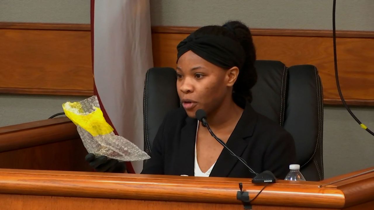 Valencia Johnson, a lab tech with the Georgia Bureau of Investigation, inspects an exhibit item in court on Tuesday in Athens, Georgia.