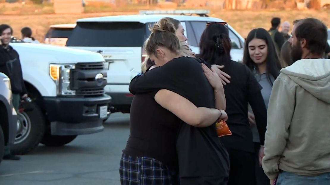 People hug at a reunification center at Oroville Church of the Nazarene in Oroville, California, on December 4, 2024.