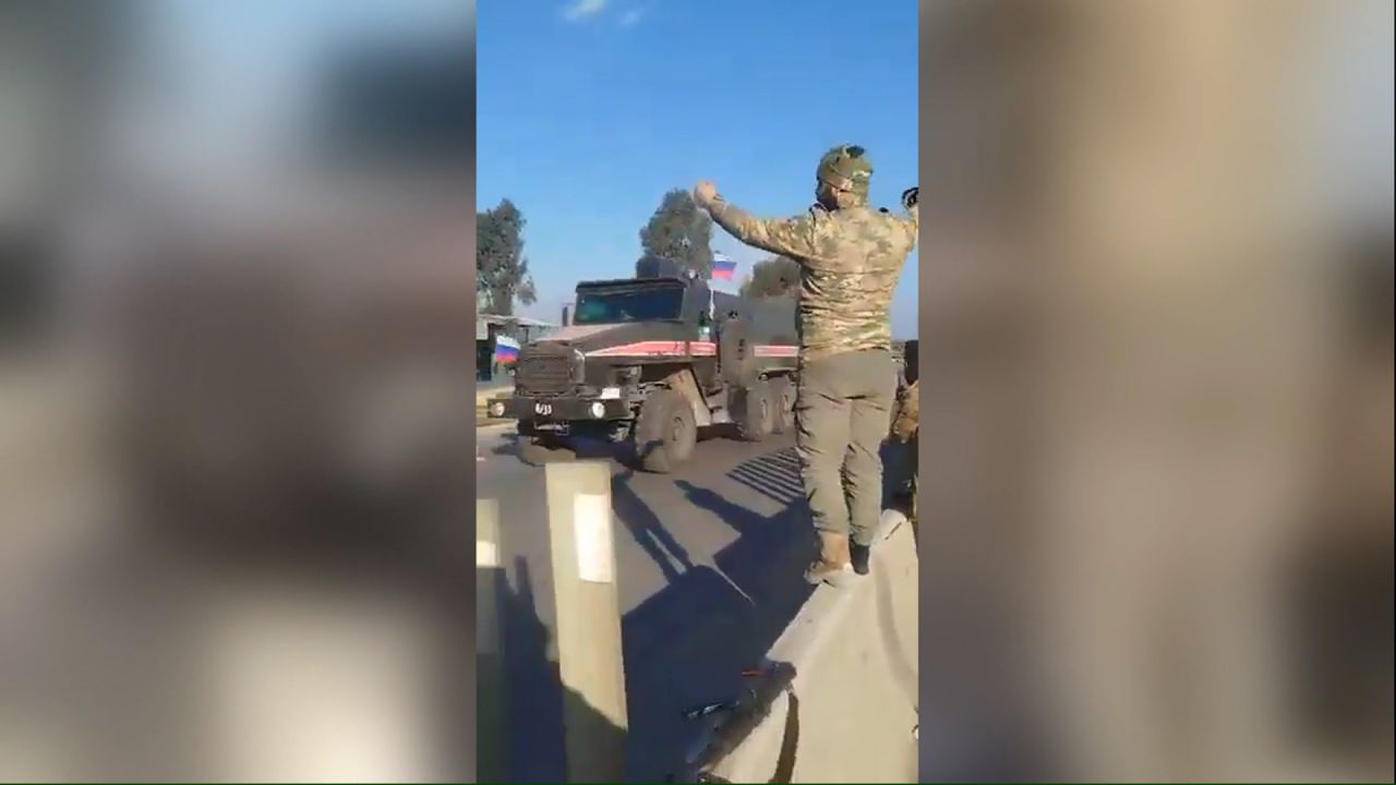 In a video shot on the outskirts of Homs, military trucks, armoured personnel carriers and SUVs bearing Russian flags can be seen moving westbound on the M1 highway that leads to Russian bases near the Syrian coast.