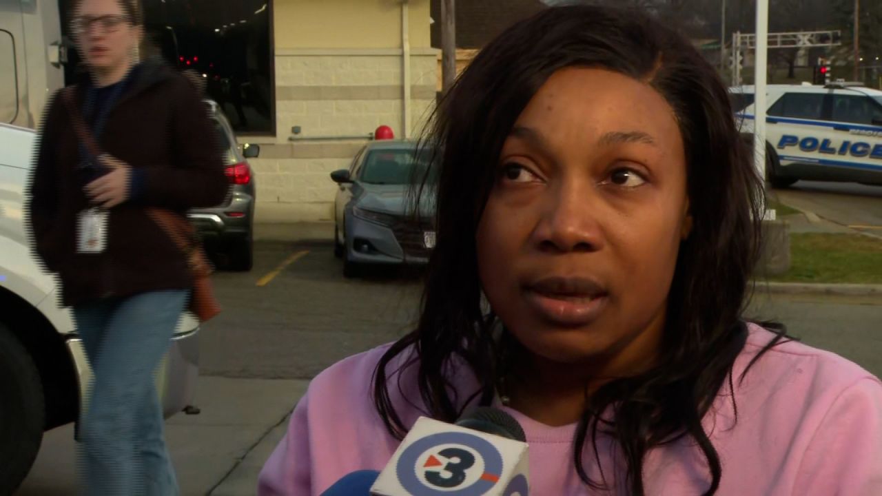 Mireille Jean-Charles talks to reporters.