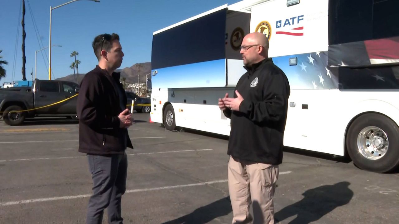 ATF team leader Chris Forkner, right, speaks with CNN's Josh Cambell outside a mobile command center.