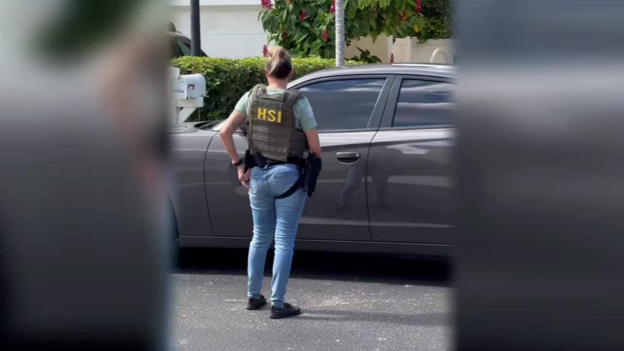 An immigration agent stands in front of Dante Lopez's home in Florida.