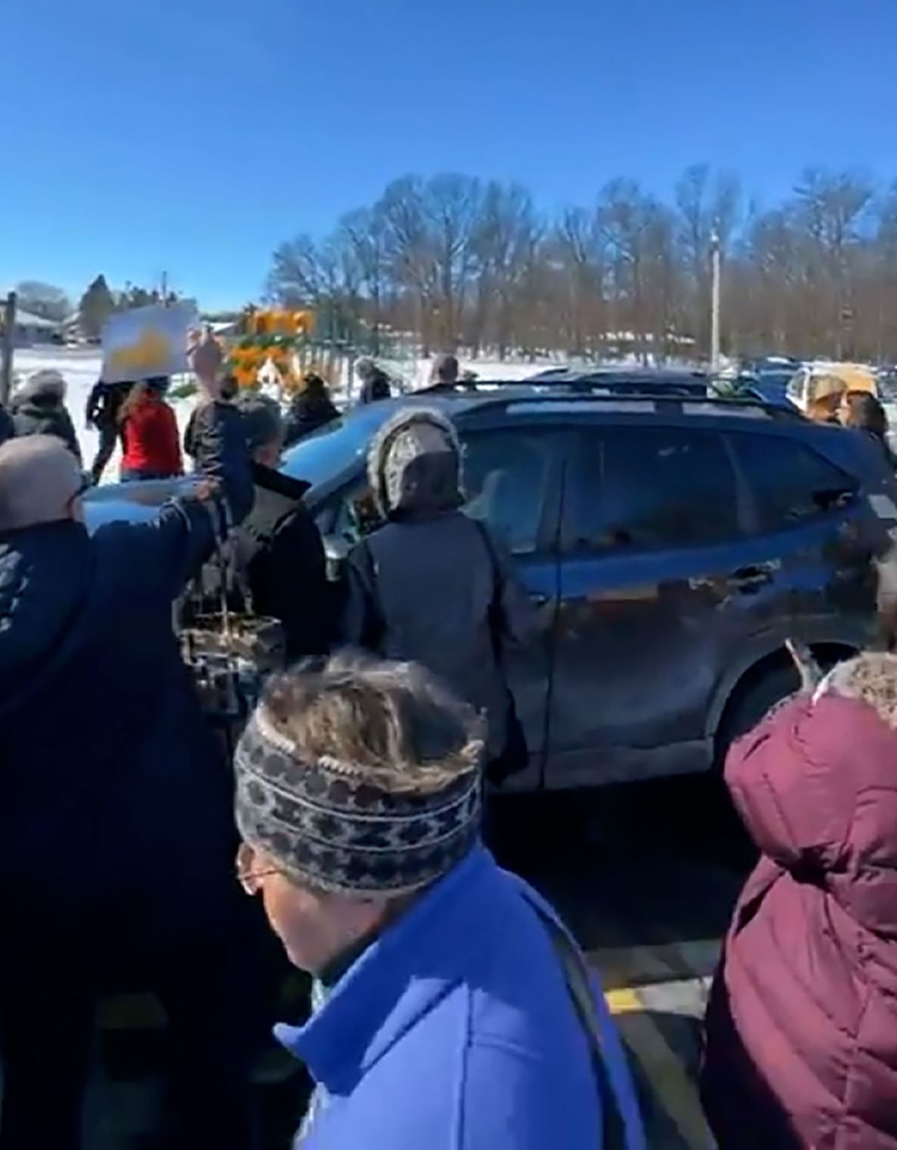 Constituents boo Rep. Grothman outside the town hall in Oshkosh, Wisconsin, on Sunday.