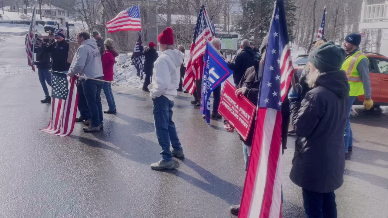 Supporters hold signs and flags as in Warren, Vermont, on Saturday.
