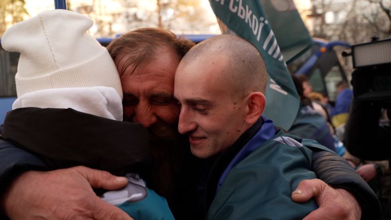 Watch: Ukrainian prisoners of war embrace family members in emotional return from Russia