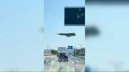 An aircraft believed to be China's new J-36 fighter jet is seen flying over a highway near the runway of Chengdu Aircraft Industry Group.