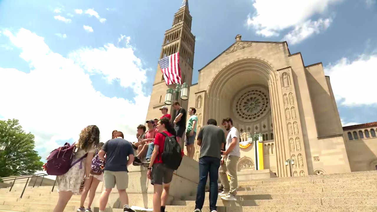 Young people gather on the steops of the Basilica of the National Shrine of the Immaculate Conception in Washington, DC, on Thursday after the announcement of the new pope.