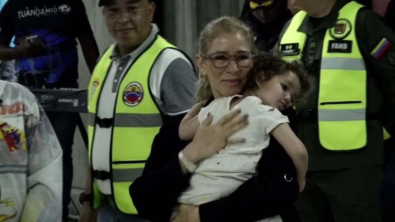 First lady of Venezuela, Cilia Flores, carries Maikelys Antonella Espinoza Bernal upon her return to Venezuela at Simon Bolivar International Airport on May 14, 2025.