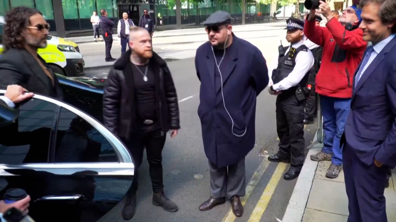 Russell Brand emerges from car outside of Southwark County Court