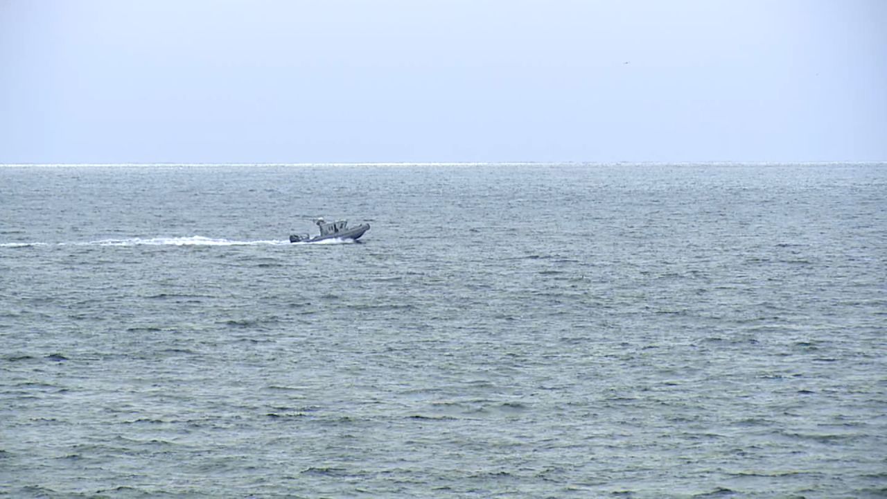 A boat searches for survivors of a plane crash near Point Loma, San Diego, on Monday.