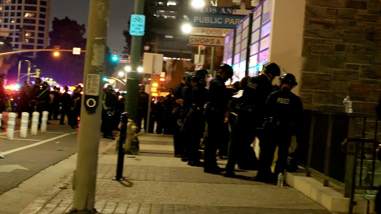 In this screengrab taken from a video, police begin to detain protesters.