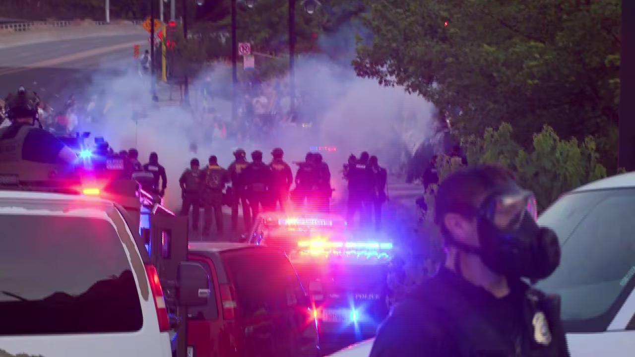 In this screengrab taken from a video, police work to disperse a crowd of protesters in Spokane, Washington, on Wednesday.