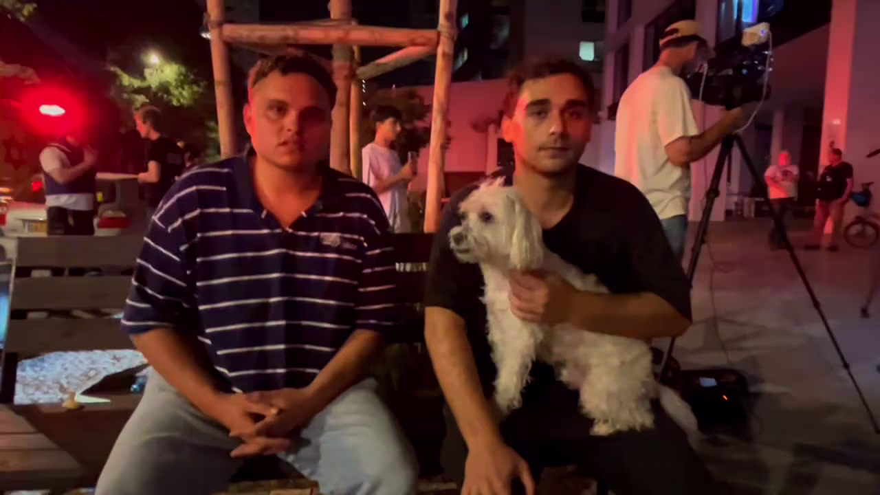 Two residents of an apartment building that was hit in Iranian strike are interviewed by CNN early Saturday.