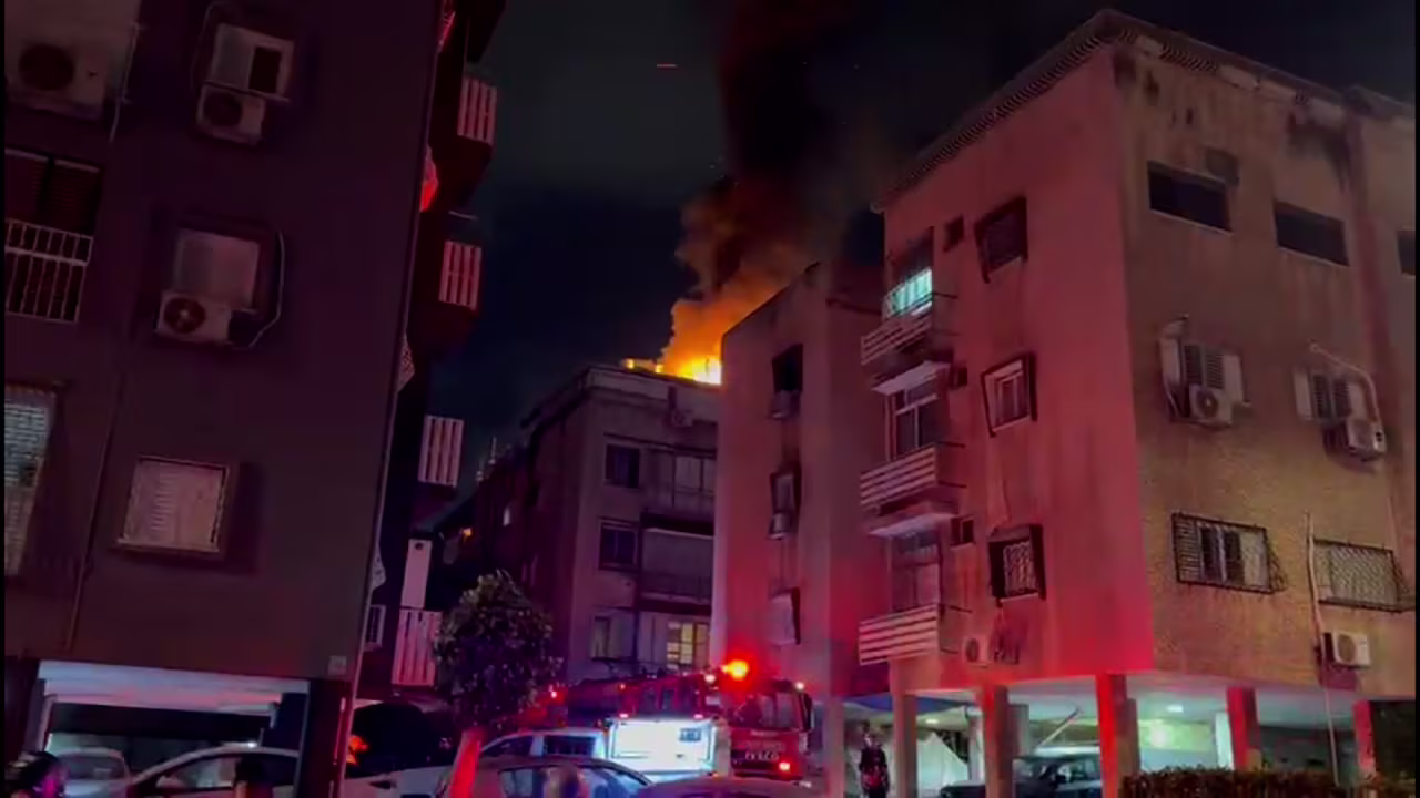 A screengrab from a video released by Israel’s national emergency services shows a building on fire in the city of Holon.