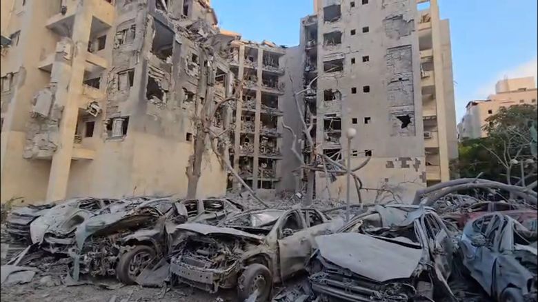 Damaged cars sits amid debris following a strike on residential building in Beer Sheva, Israel.