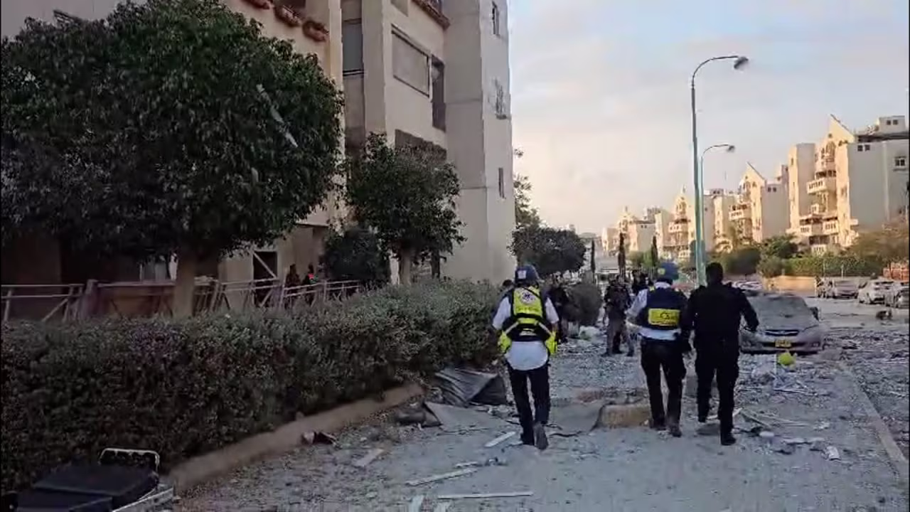 Rescue officials respond at the site after a strike on residential building in Beer Sheva, Israel.